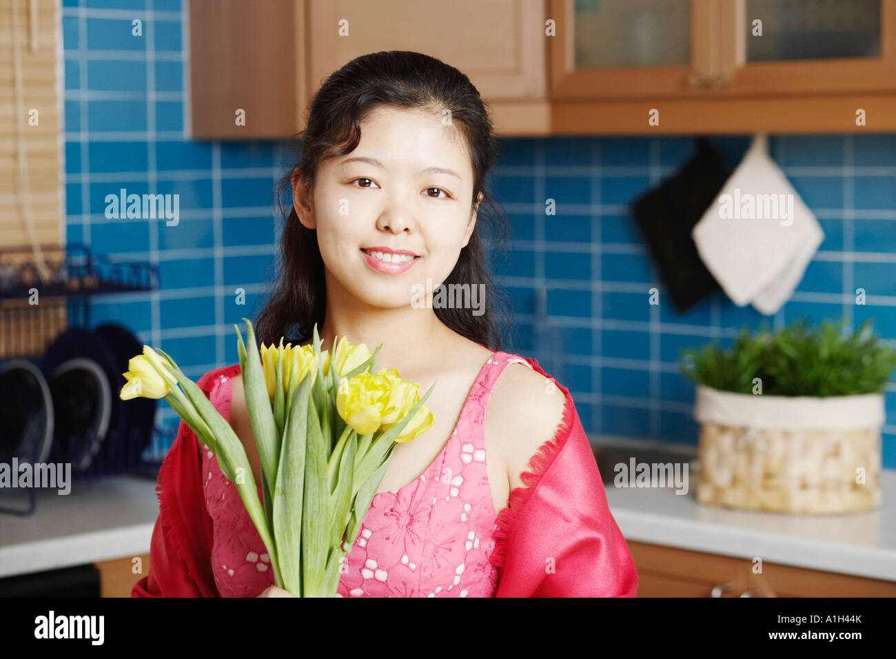Portrait of a young woman holding a bunch of flowers smiling Stock ...