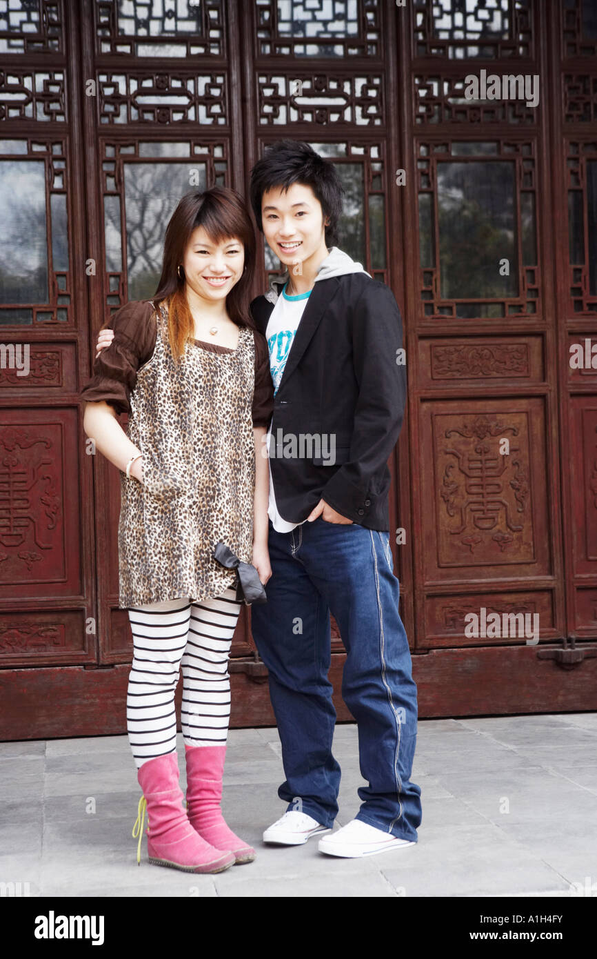 Portrait of a teenage boy standing with a young woman Stock Photo - Alamy