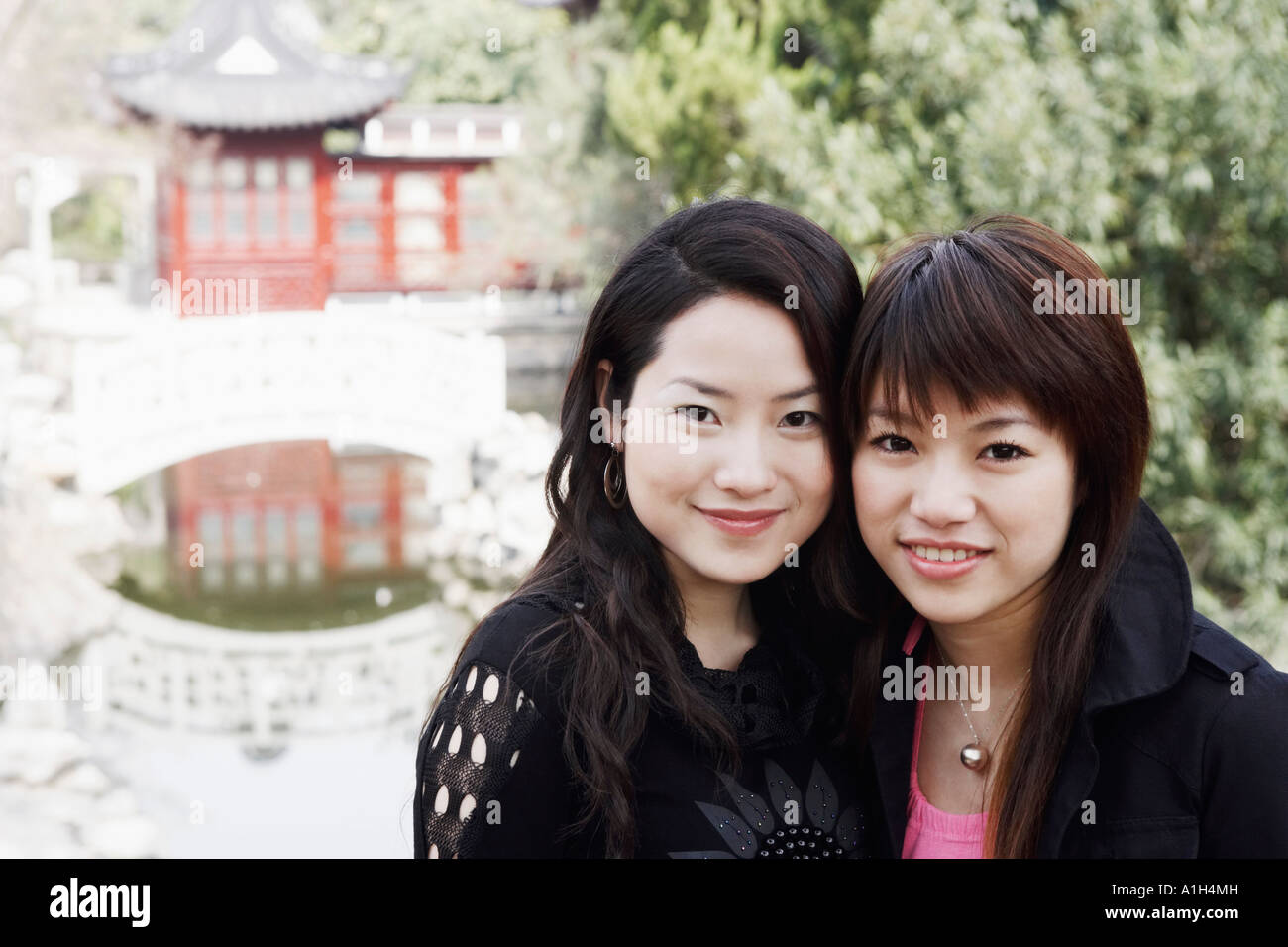 Portrait of two young women smiling Stock Photo - Alamy