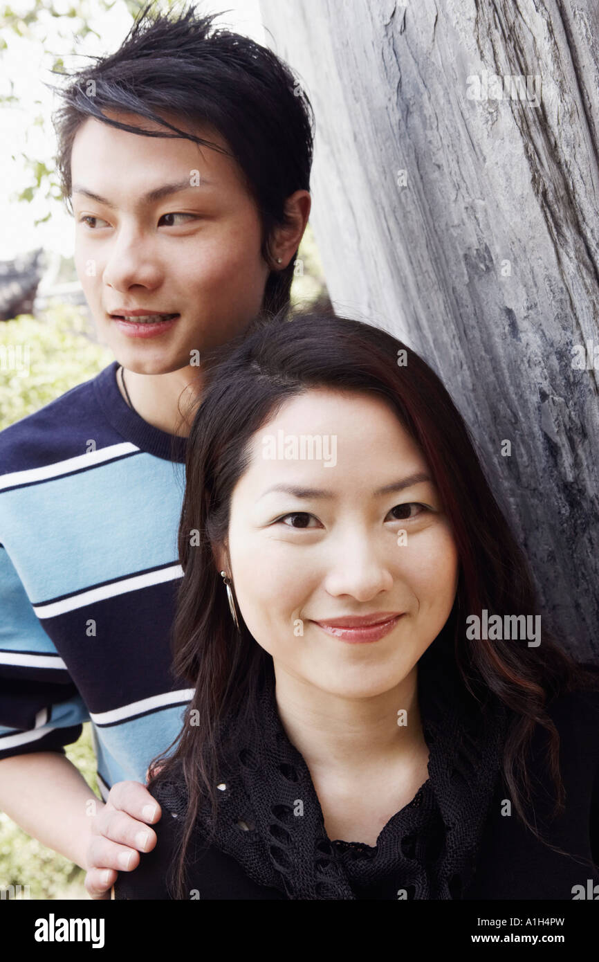 Portrait of a young woman and a young man smiling Stock Photo - Alamy