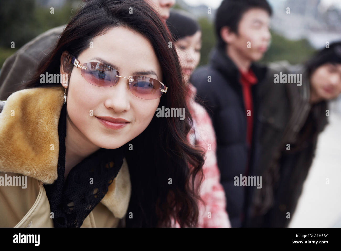 Portrait of a young woman wearing sunglasses Stock Photo - Alamy