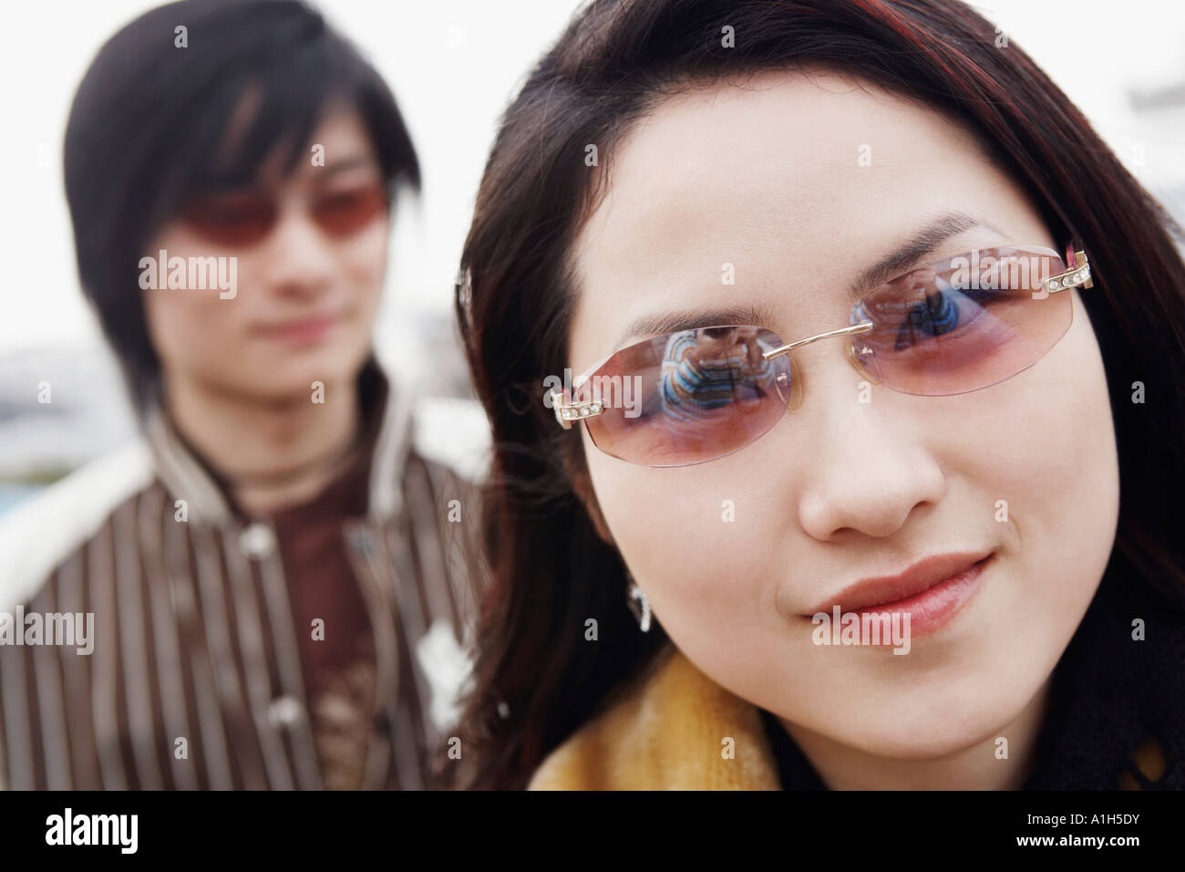 Portrait of a young woman wearing sunglasses Stock Photo - Alamy
