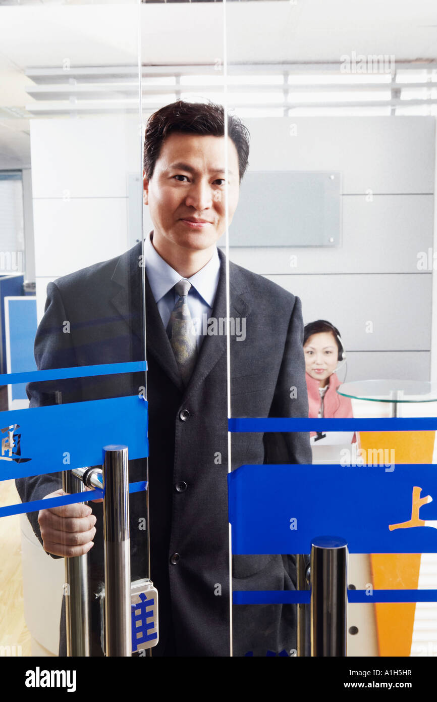 Portrait of a businessman standing in an office with a mature woman wearing a headset Stock Photo