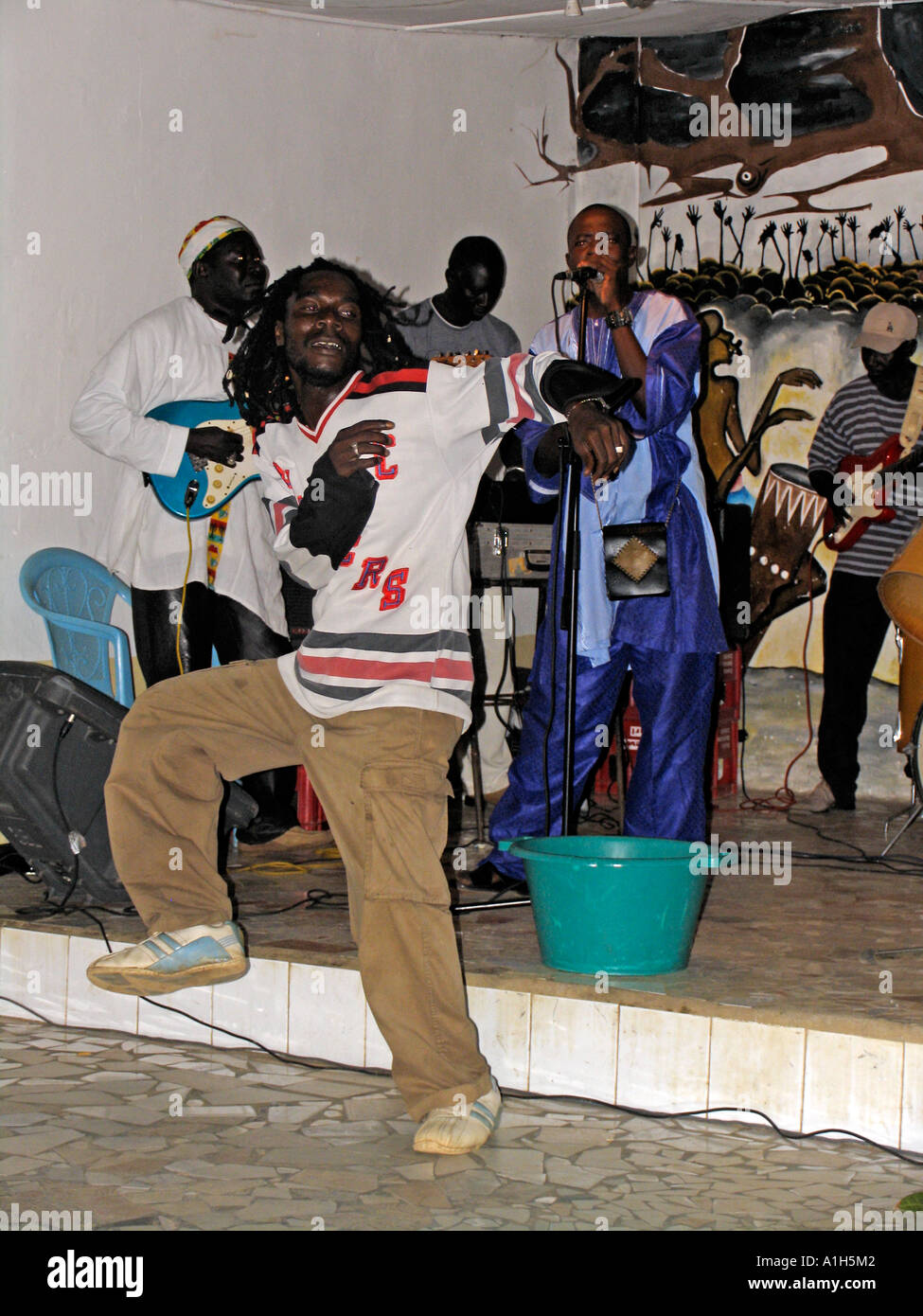 Dreadlock man dancing energetically to African band nightclub Bakau The Gambia Stock Photo