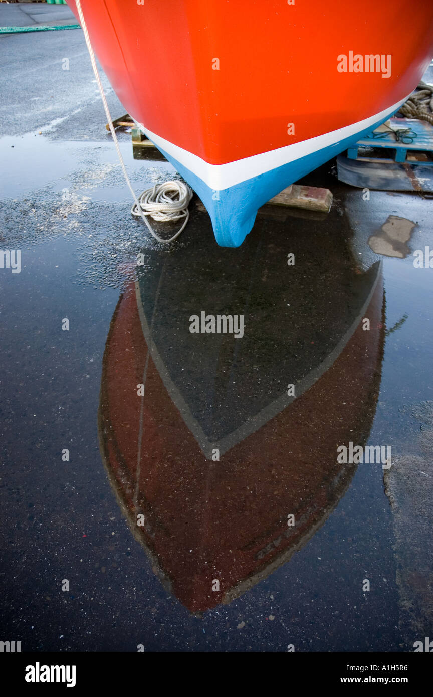 Fishing boat ashore with reflection Stock Photo - Alamy