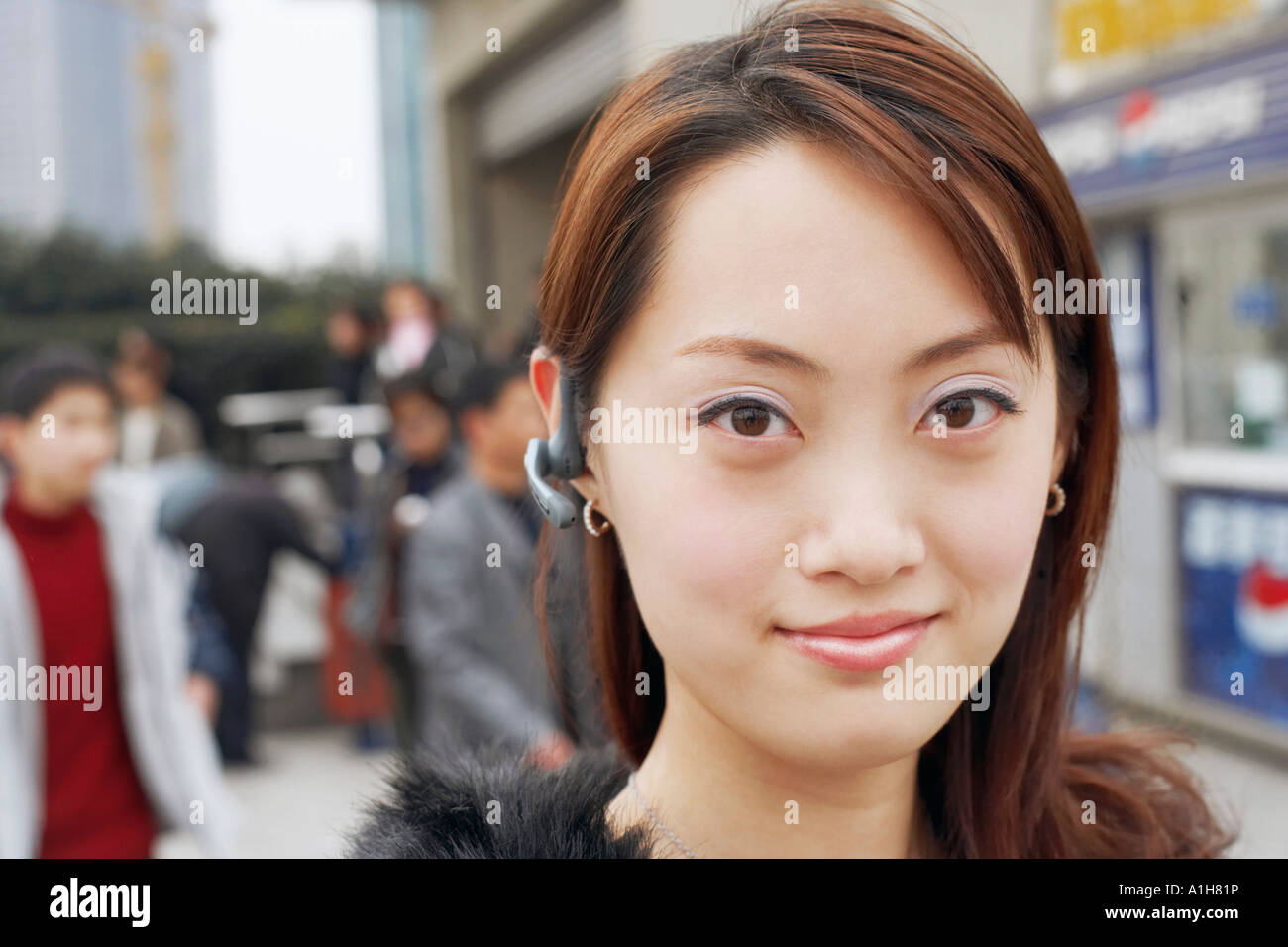 Portrait of a young woman wearing a hands free device stock photo alamy
