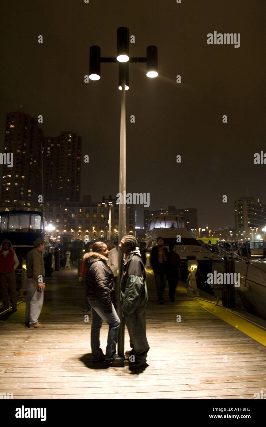 Black afro American couple under street lamp Baltimore Maryland Stock Photo