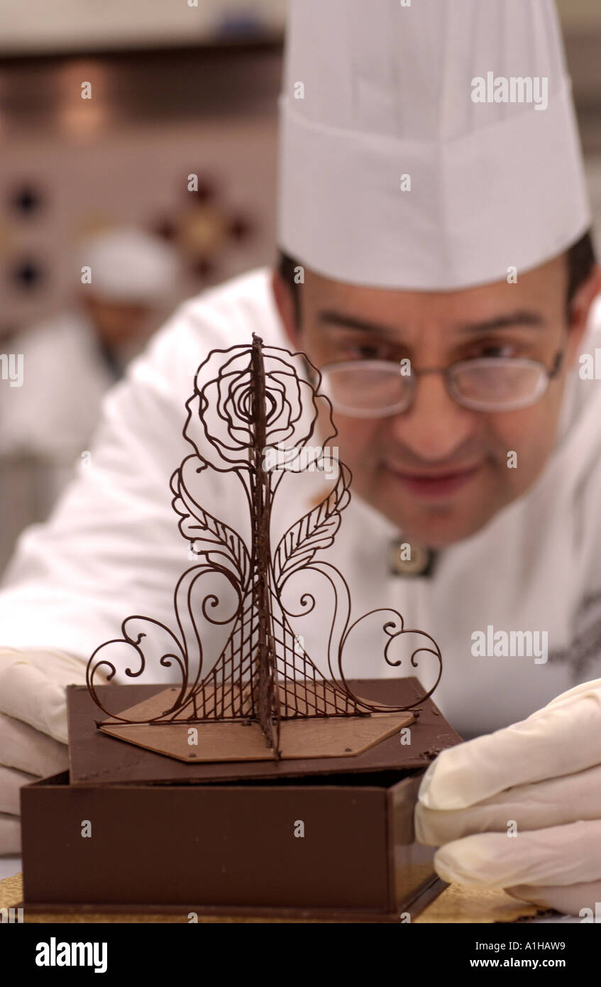 Chef working with Chocolate Lace on a cake Master Baker Stock Photo