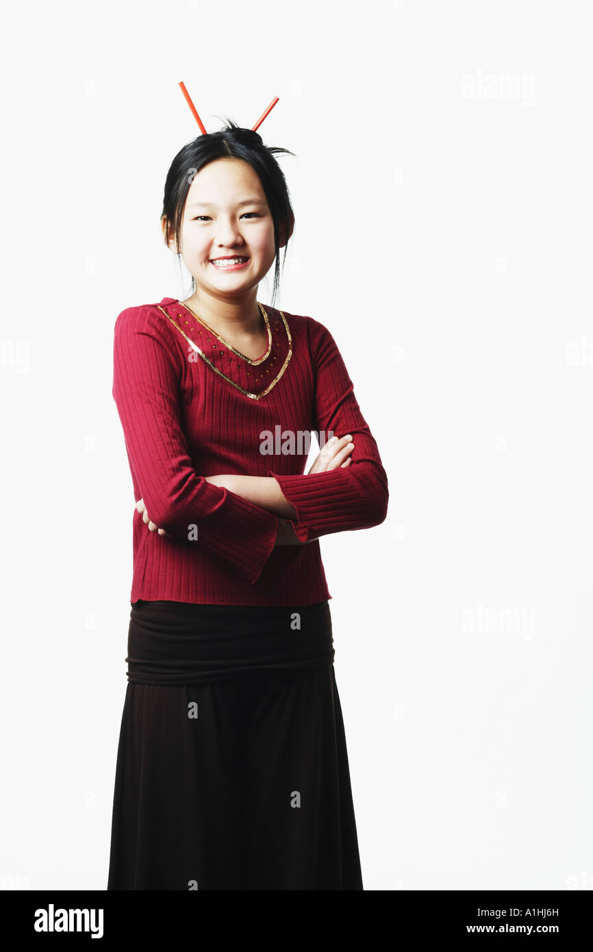 Portrait of a teenage girl smiling with her arms crossed Stock Photo ...