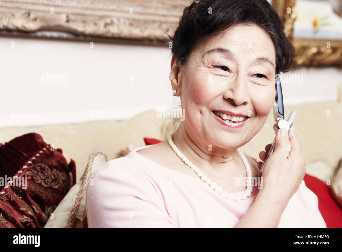 Close-up of a senior woman talking on a mobile phone Stock Photo - Alamy