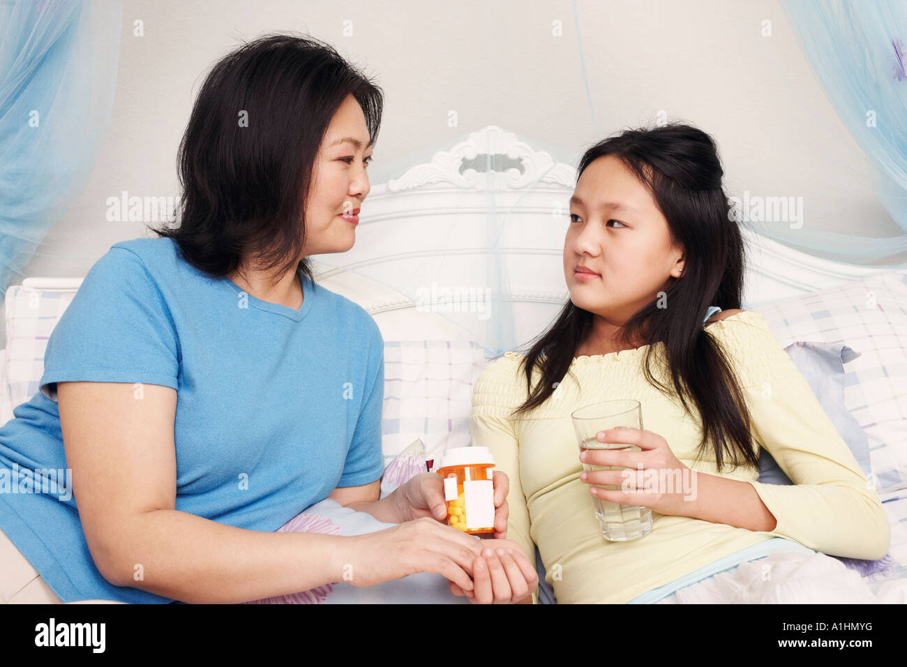 Closeup of a mother giving her daughter medicine Stock Photo Alamy