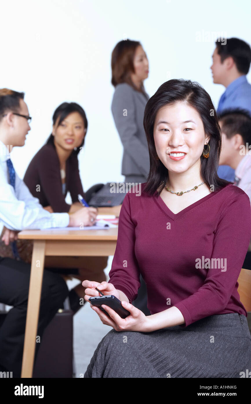 Portrait of a businesswoman holding a personal data assistant Stock ...