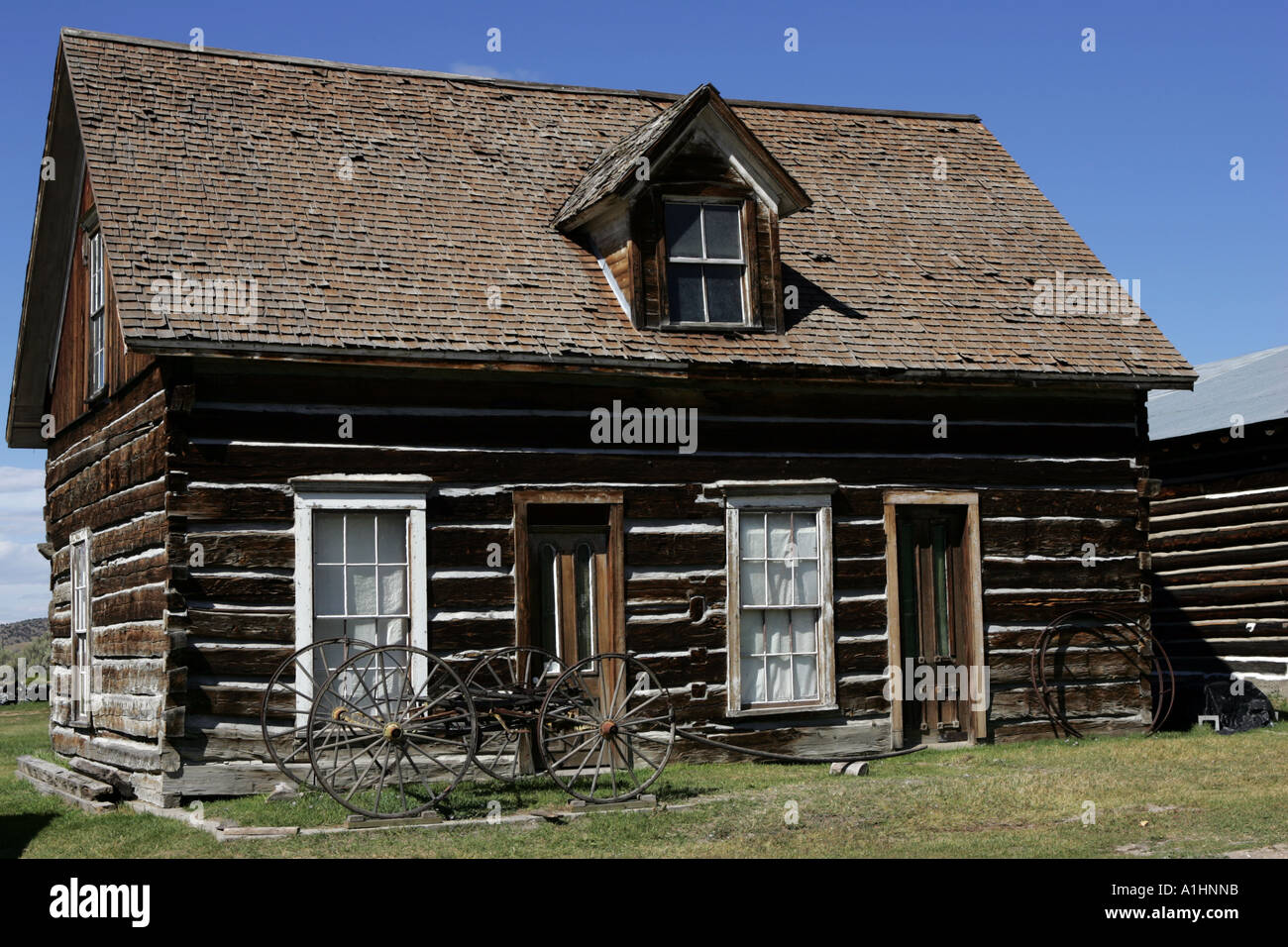 Old Log Cabin With Wagon Chassis Outside In Nevada City Mining