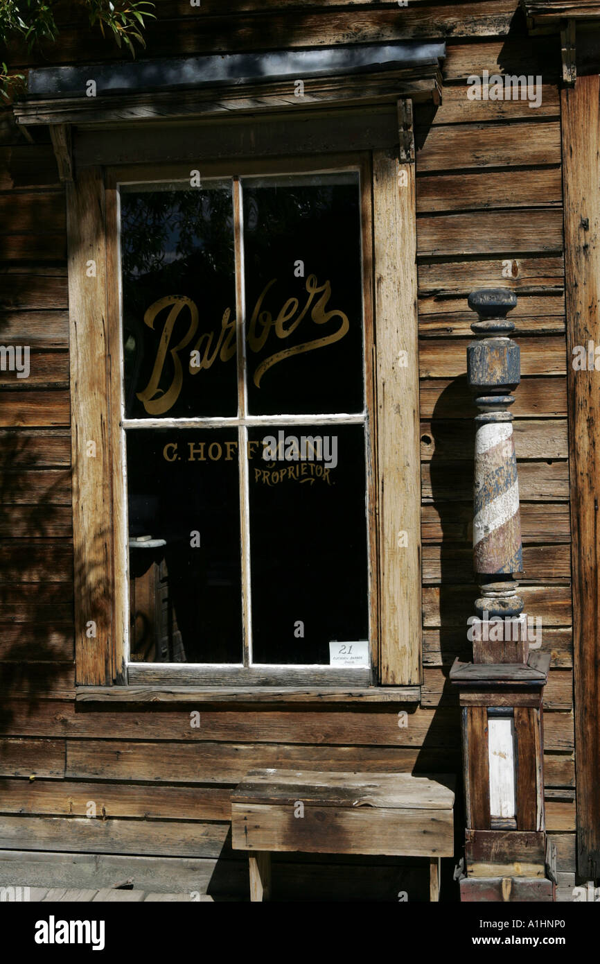 Old wooden window and building at an old Barbers shop with barbers pole in Nevada City Montana USA Stock Photo
