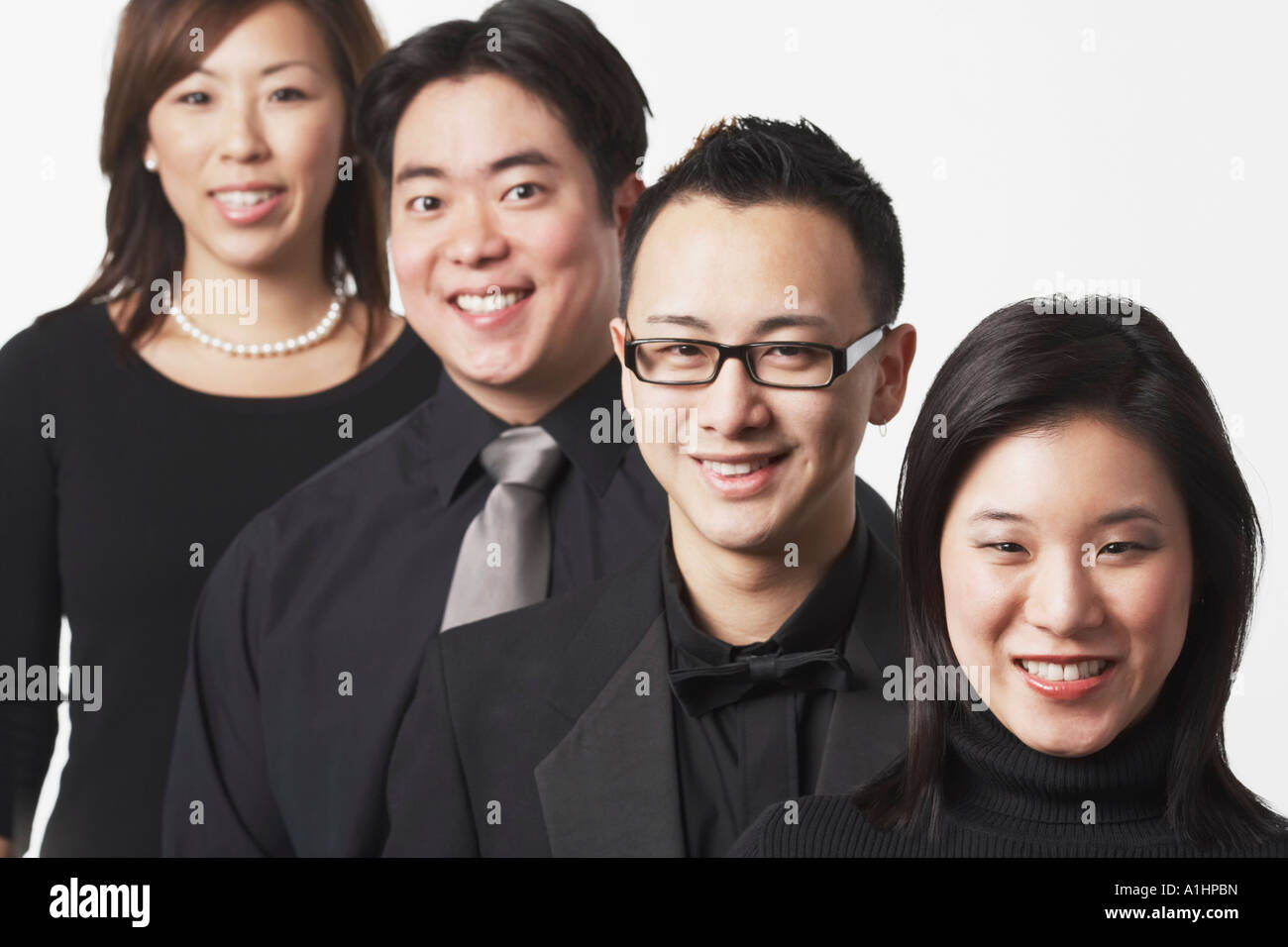 Portrait of two young men and two young women smiling Stock Photo - Alamy