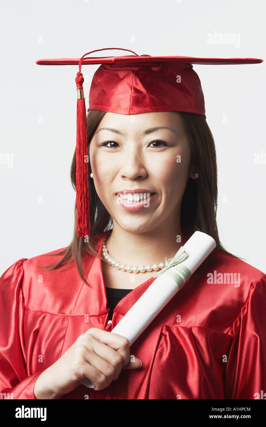 Portrait of a female graduate holding a diploma Stock Photo - Alamy