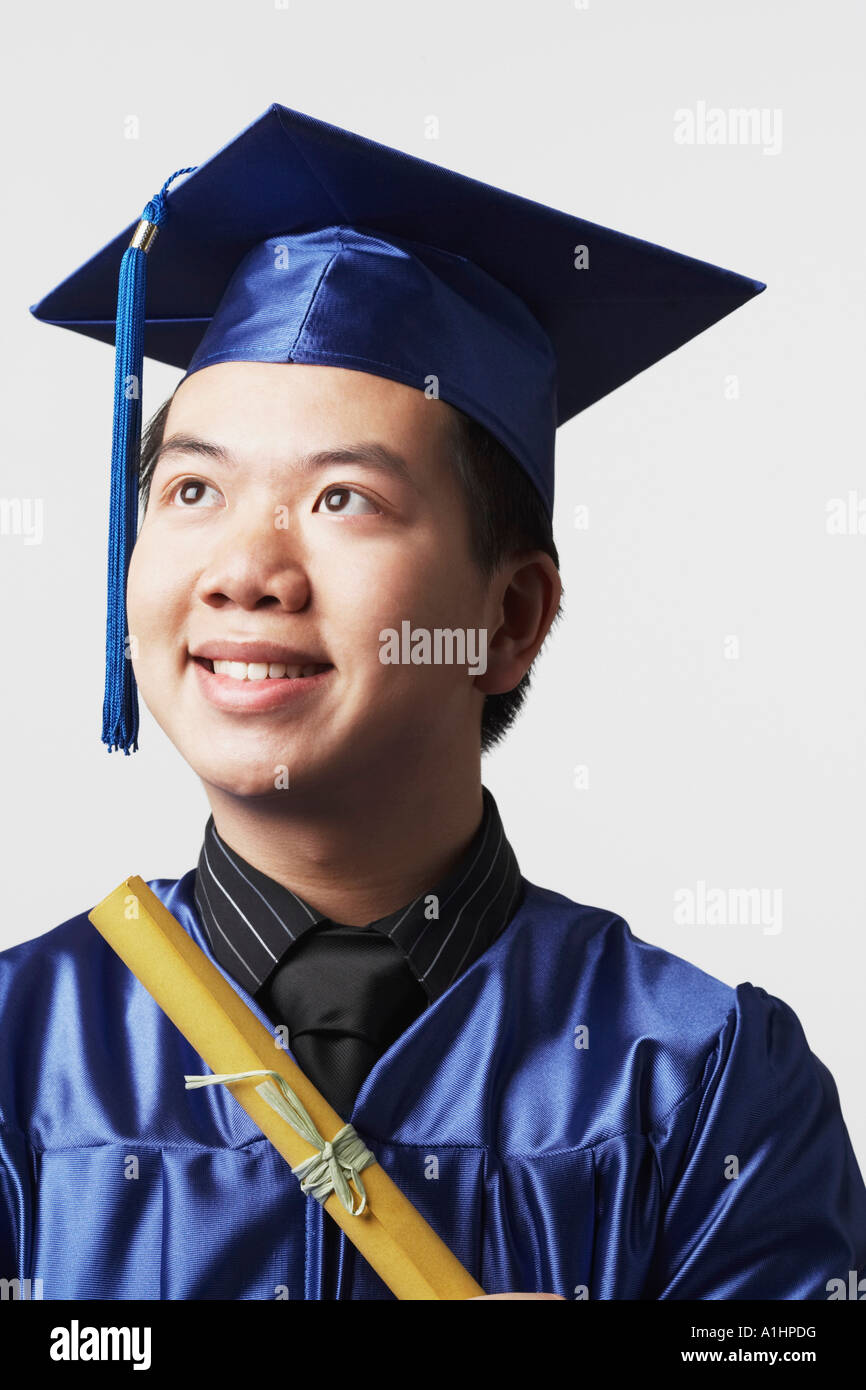 Portrait of a male graduate holding a diploma Stock Photo - Alamy