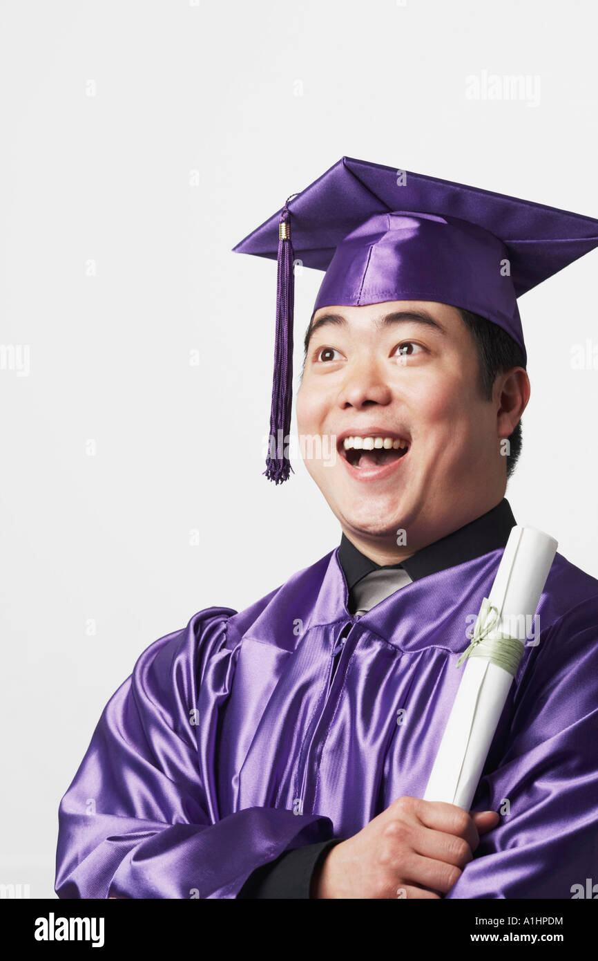 Portrait of a male graduate holding a diploma Stock Photo - Alamy