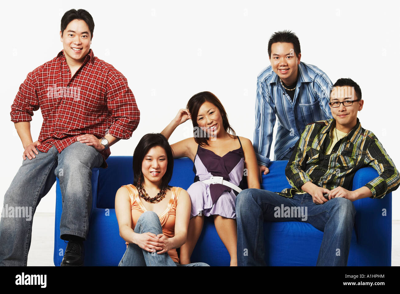Portrait of two young women and three young men smiling Stock Photo - Alamy