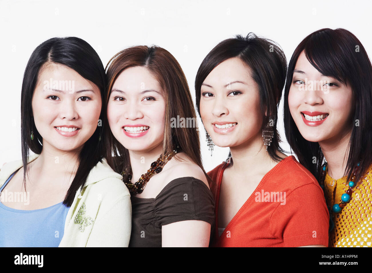 Portrait of four young women smiling Stock Photo