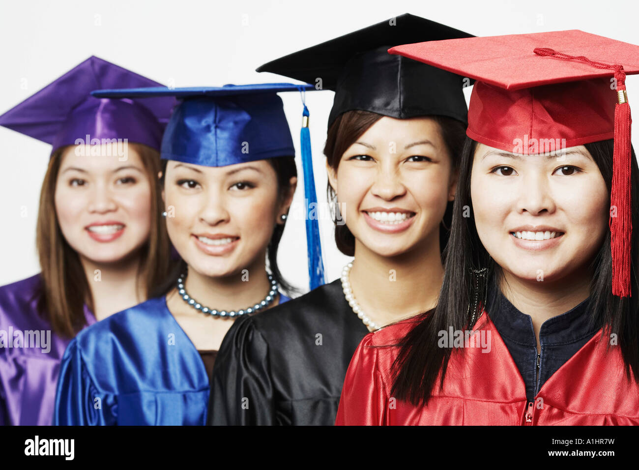 Portrait of four female graduates standing in a row Stock Photo - Alamy