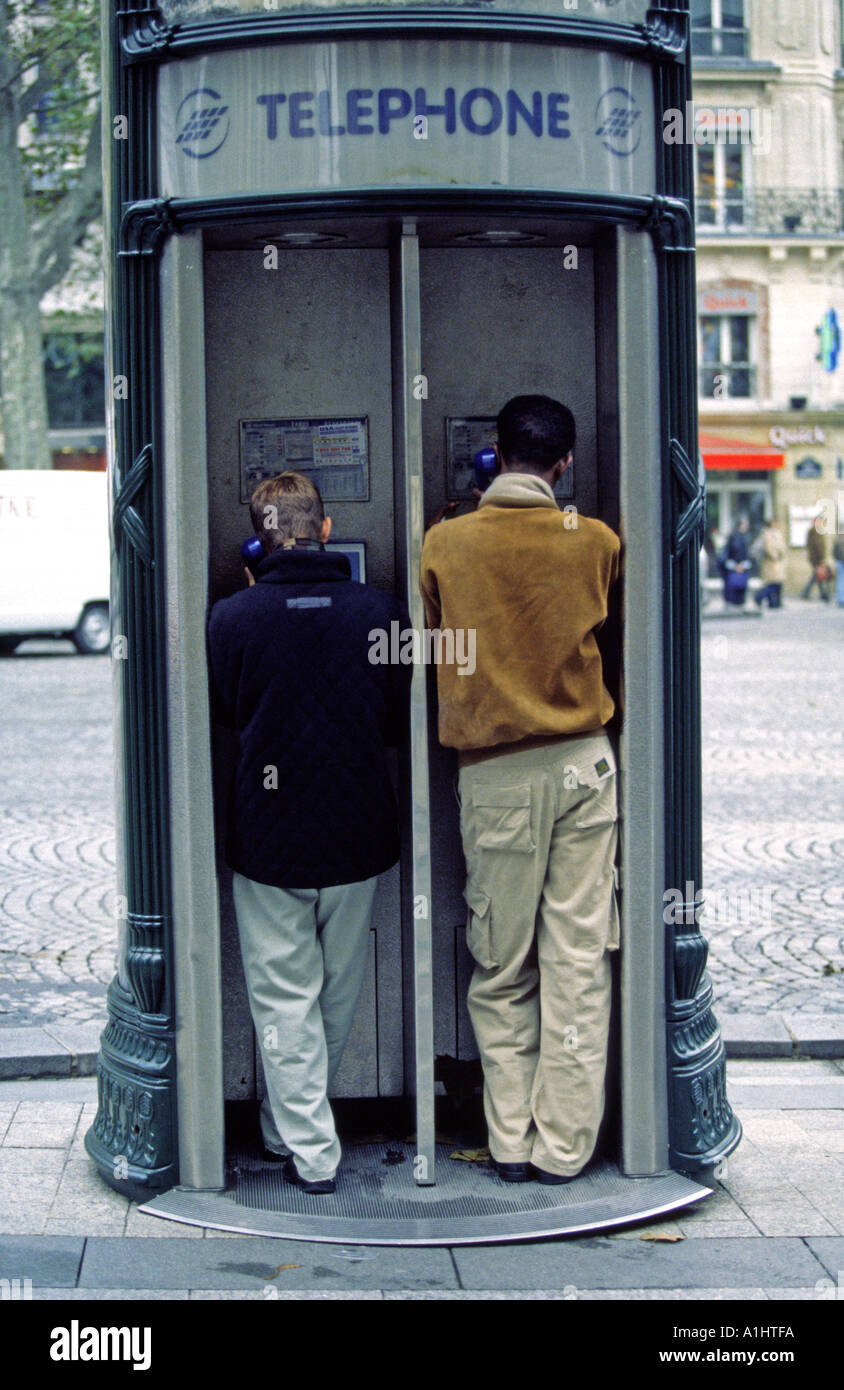 Two personn in public phone Paris France Stock Photo