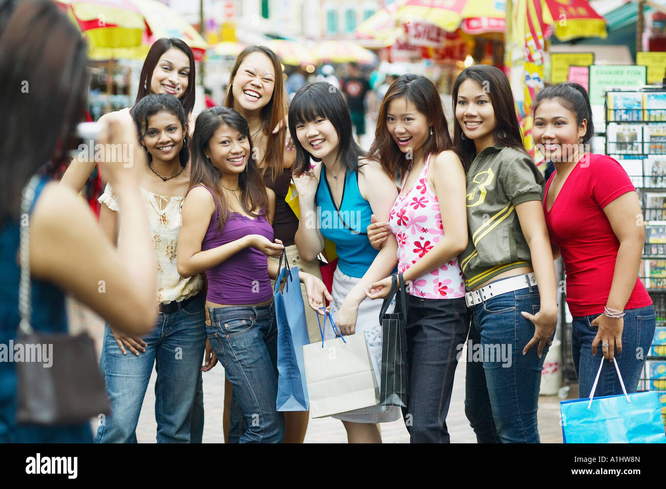 Young woman taking a photograph of her friends Stock Photo