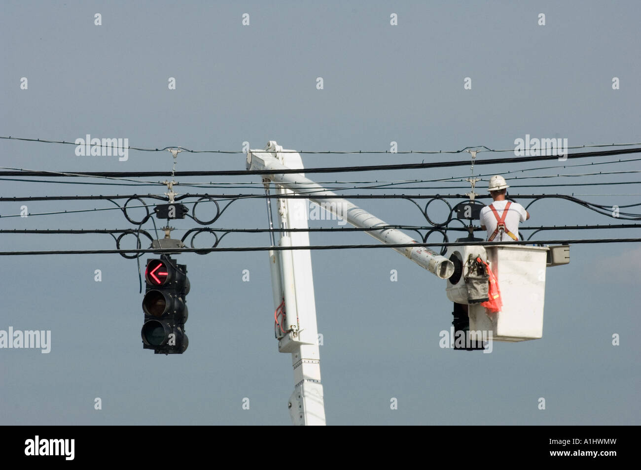 man working on street lights traffic signals bucket truck cherry picker