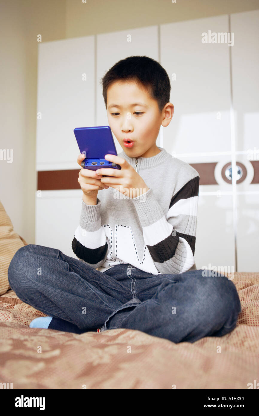 Boy playing a video game Stock Photo Alamy