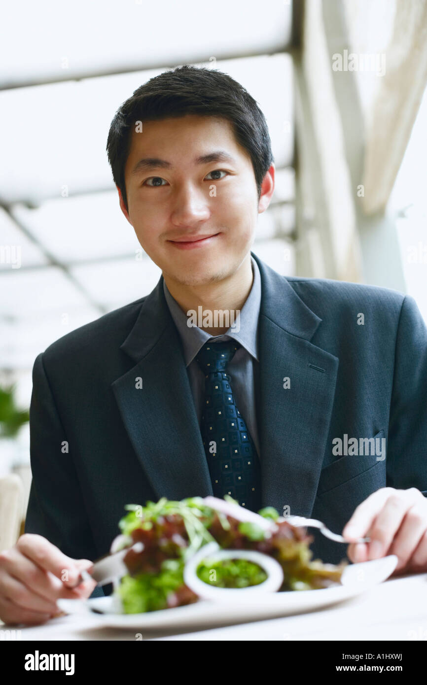 Portrait of a businessman seated at the table in a restaurant smiling Stock Photo