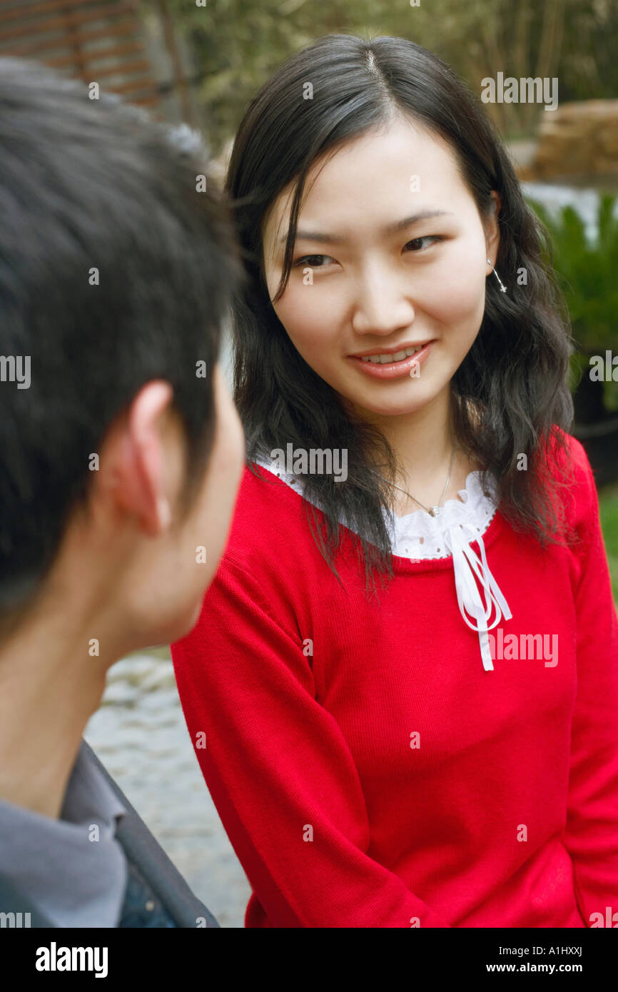 Young couple looking at each other smiling Stock Photo - Alamy