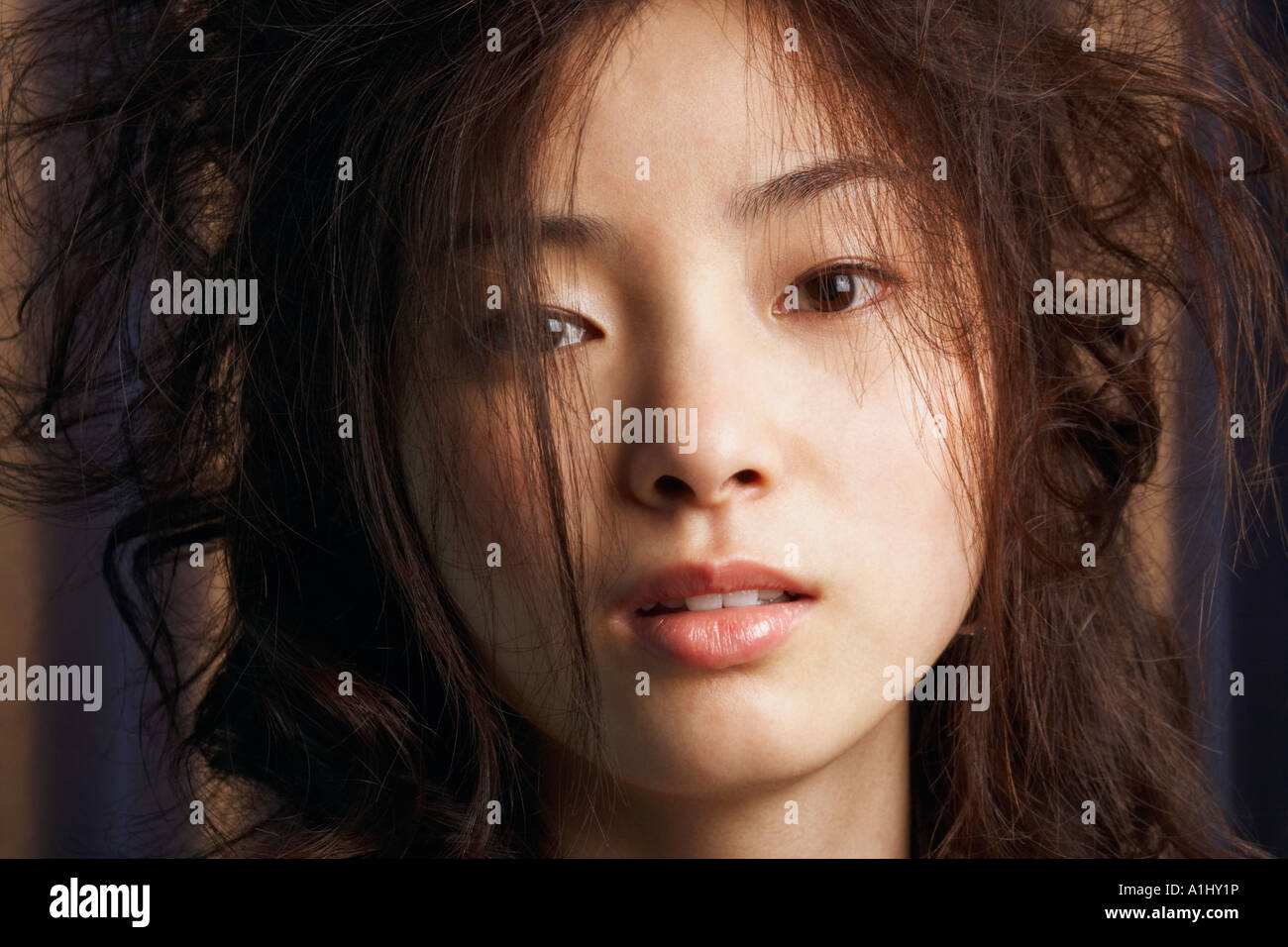 Portrait of a young woman with tousled hair Stock Photo