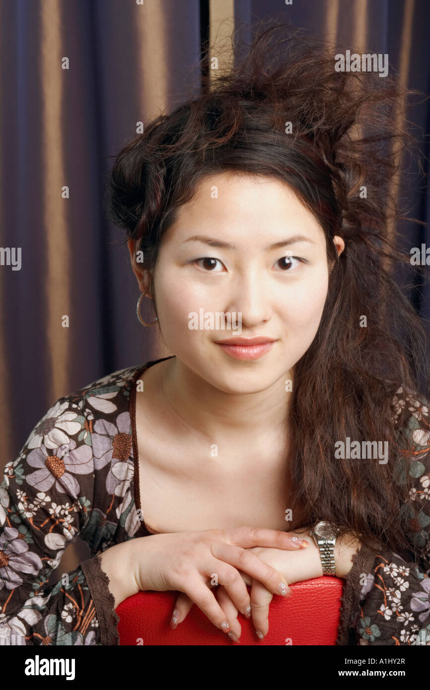 Portrait of a teenage girl sitting on a chair smiling Stock Photo - Alamy