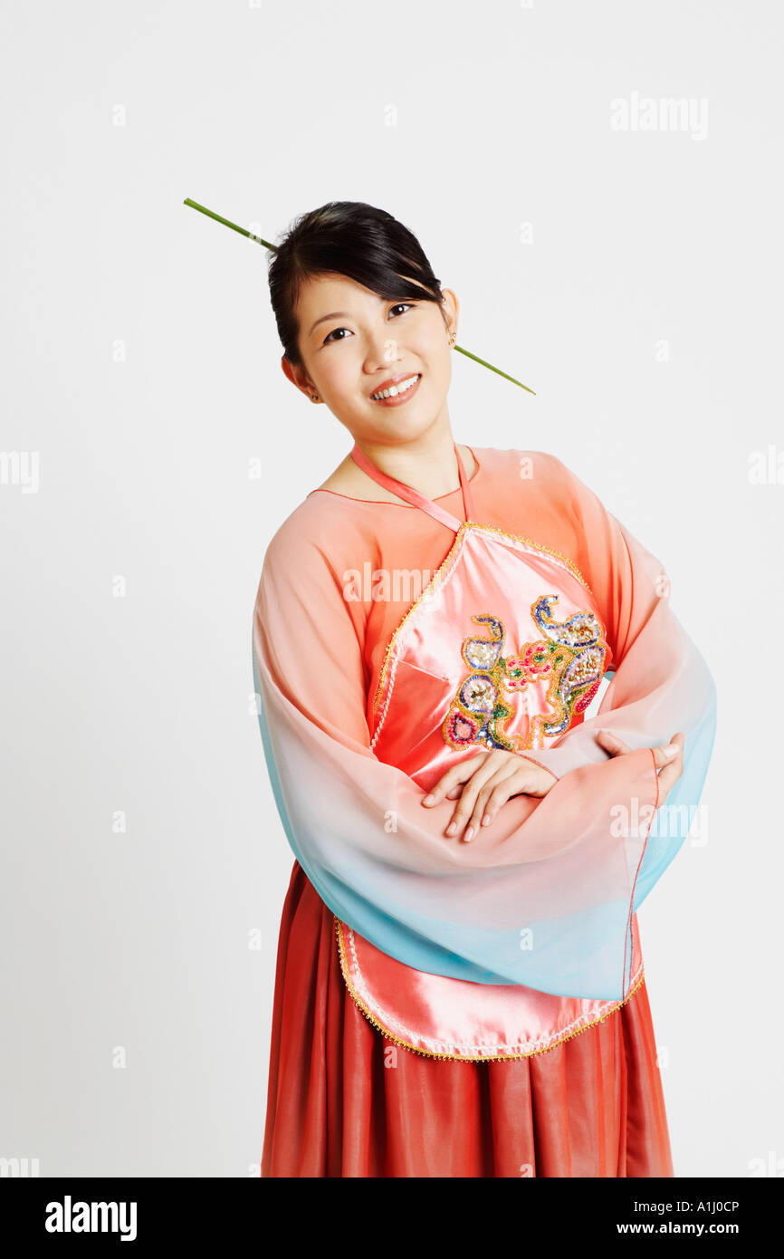 Portrait of a young woman wearing traditional clothing and smiling ...