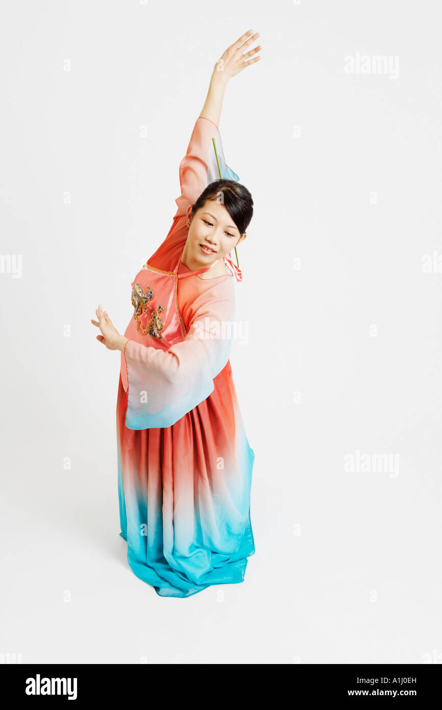 Close-up of a young woman wearing traditional clothing and dancing Stock Photo