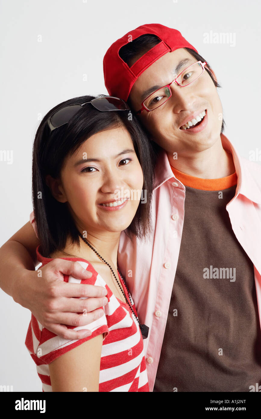 Portrait of a young woman and a mid adult man smiling Stock Photo - Alamy