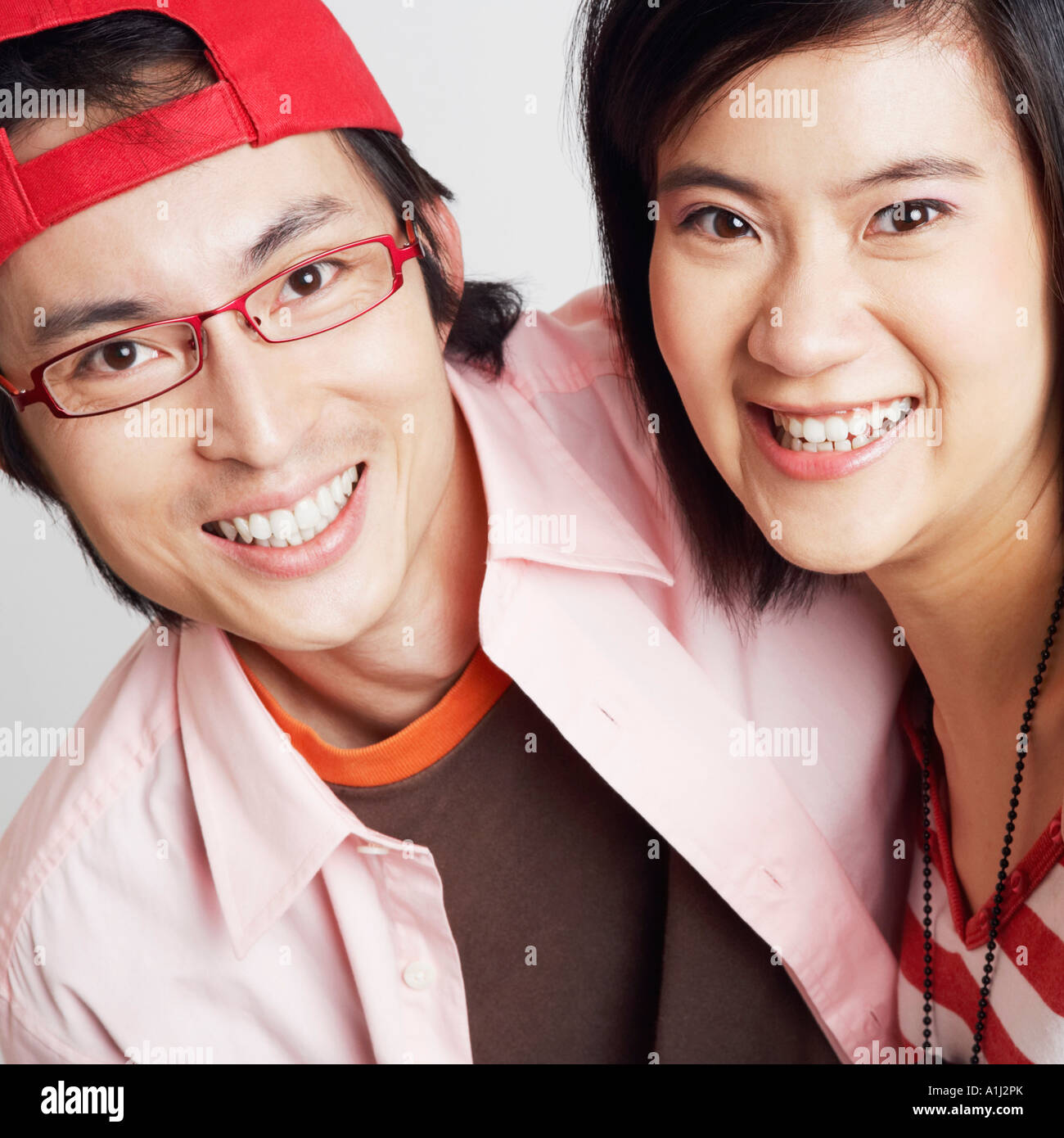 Portrait of a young woman and a mid adult man smiling Stock Photo - Alamy