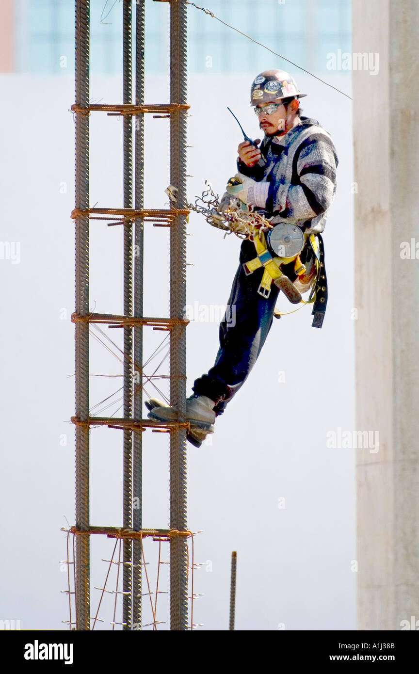 Construction workers with protective clothing and hard hats work on building in Sarasota Florida Stock Photo