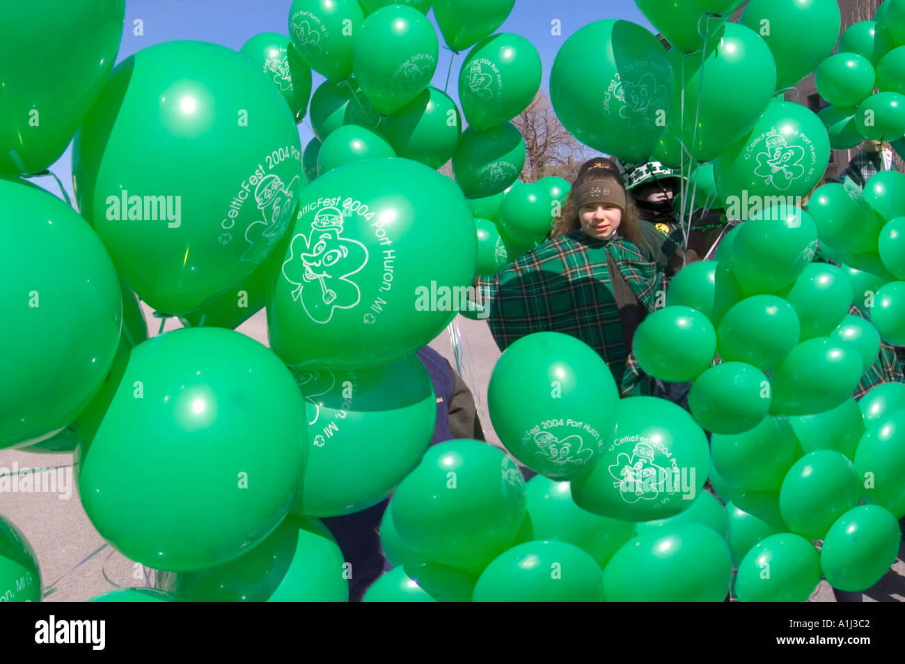 Activities at a Saint Patrick s Day Parade in Port Huron Michigan child with green balloons Stock Photo
