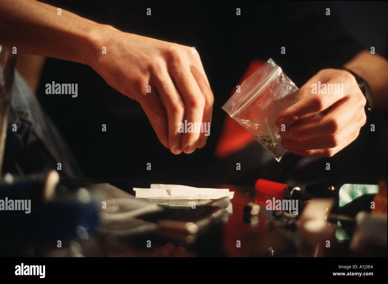 Close up of hands rolling joint Stock Photo