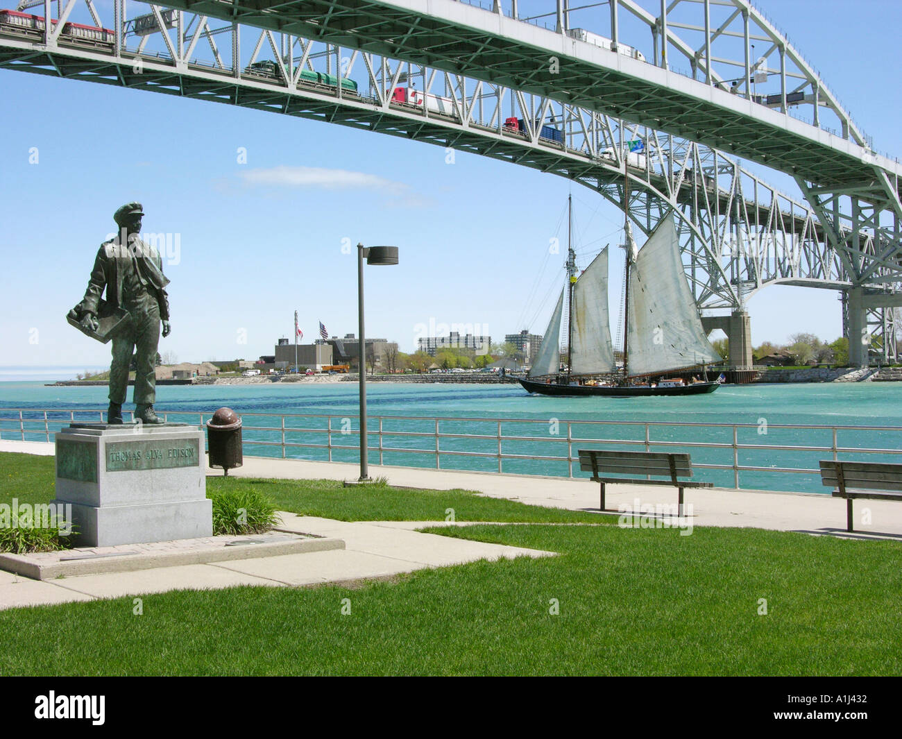 Thomas Edison Statue Stands under the Blue Water International Bridge at Port Huron Michigan Stock Photo