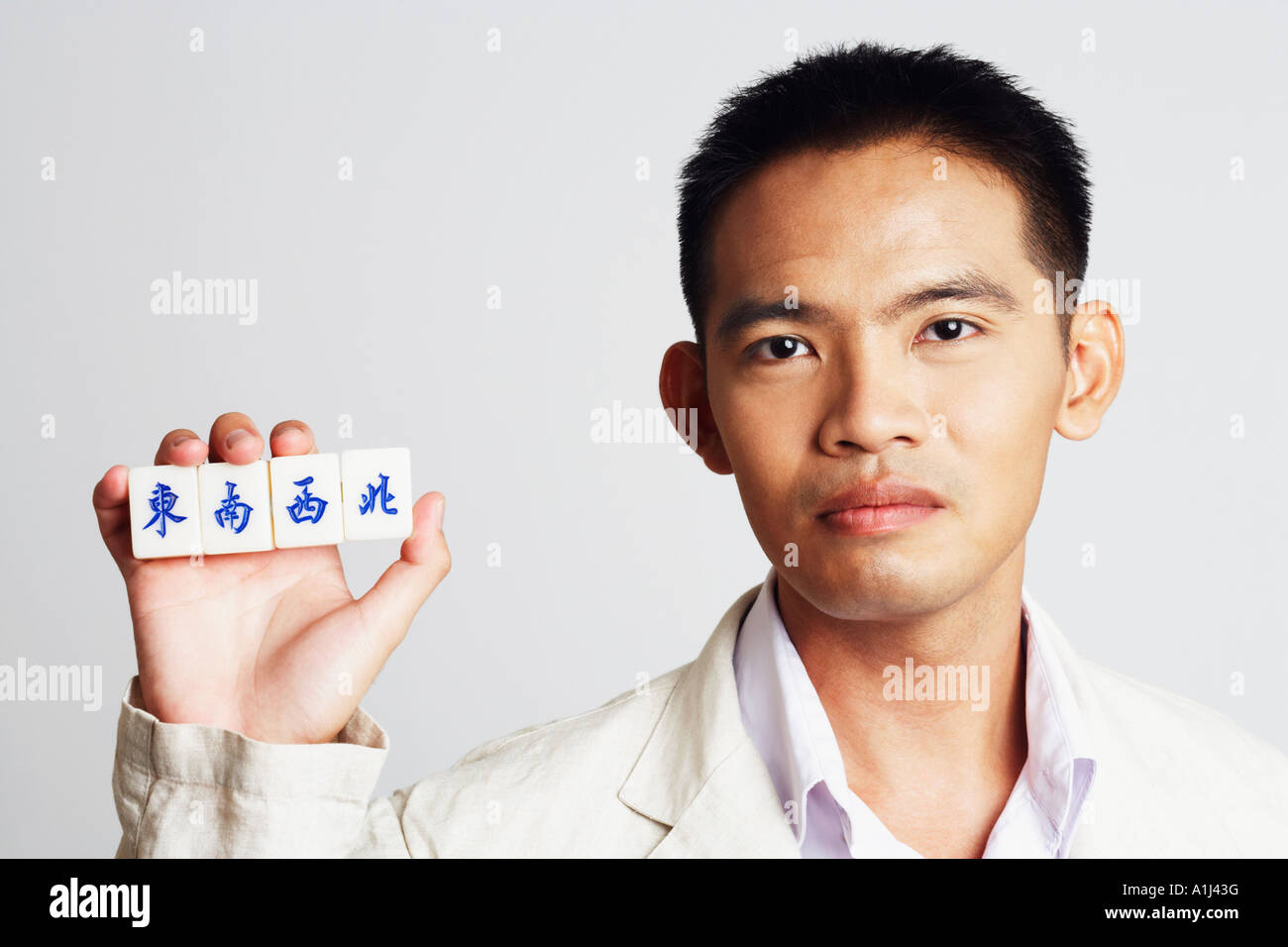 Portrait of a businessman holding marble cubes Stock Photo
