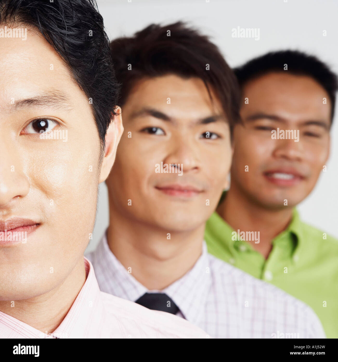 Portrait of three businessmen smiling Stock Photo - Alamy