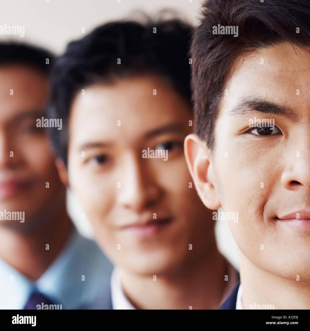Portrait of three businessmen smiling Stock Photo - Alamy