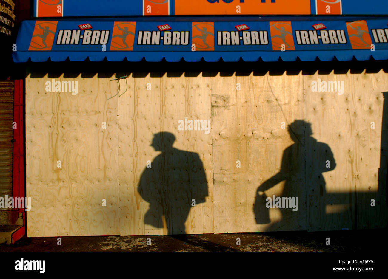 Shadows of customers at a boarded up Newsagents in Blackpool, Lancashire Stock Photo