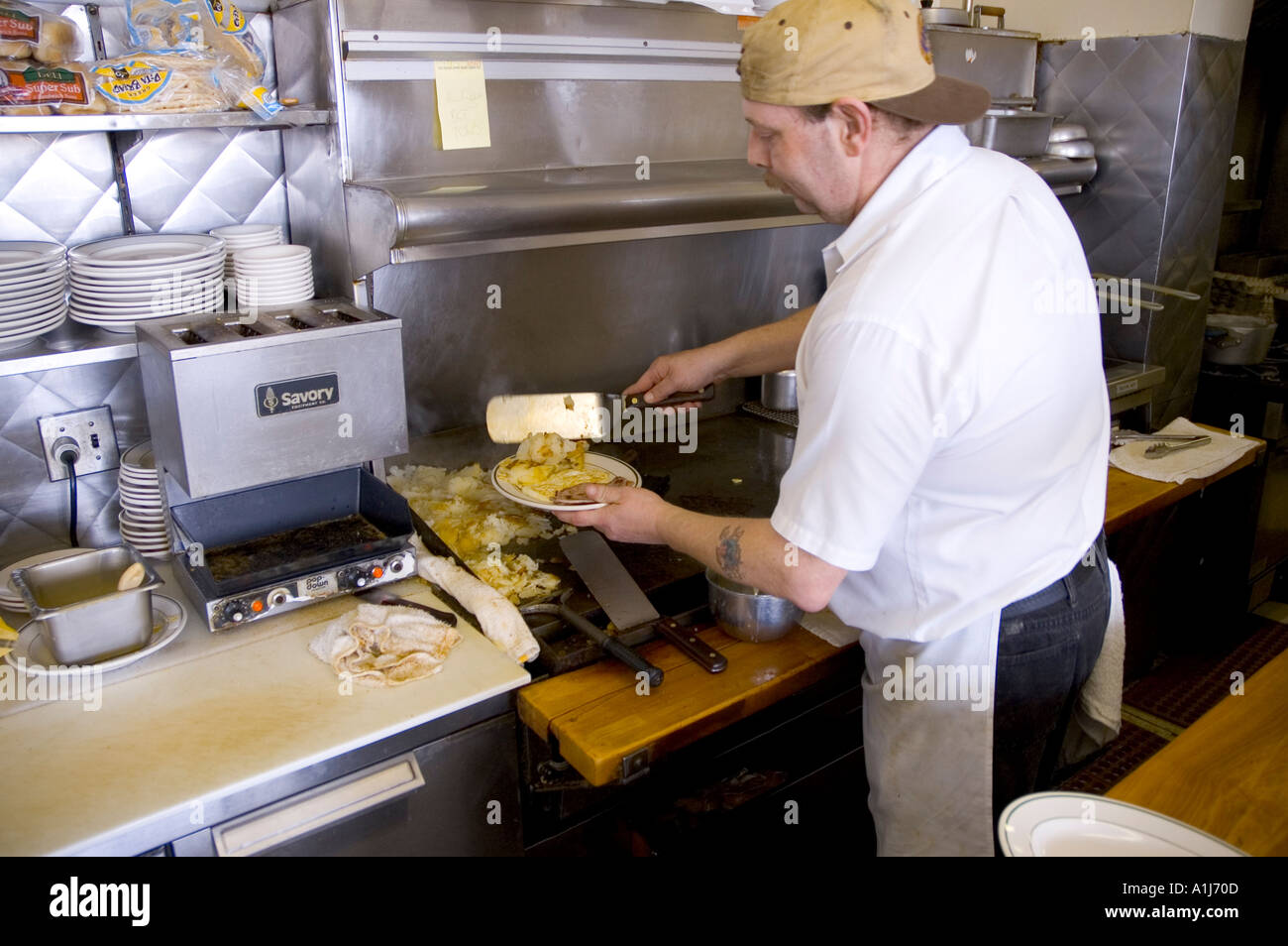 Short order cook preparing food on a grill in a small restaurant Stock  Photo - Alamy