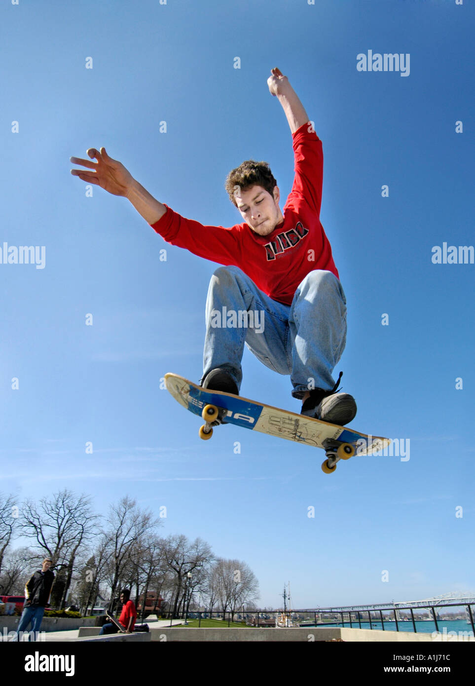 Male teen practices maneuvers on a skate board while jumping high into the air Stock Photo Alamy