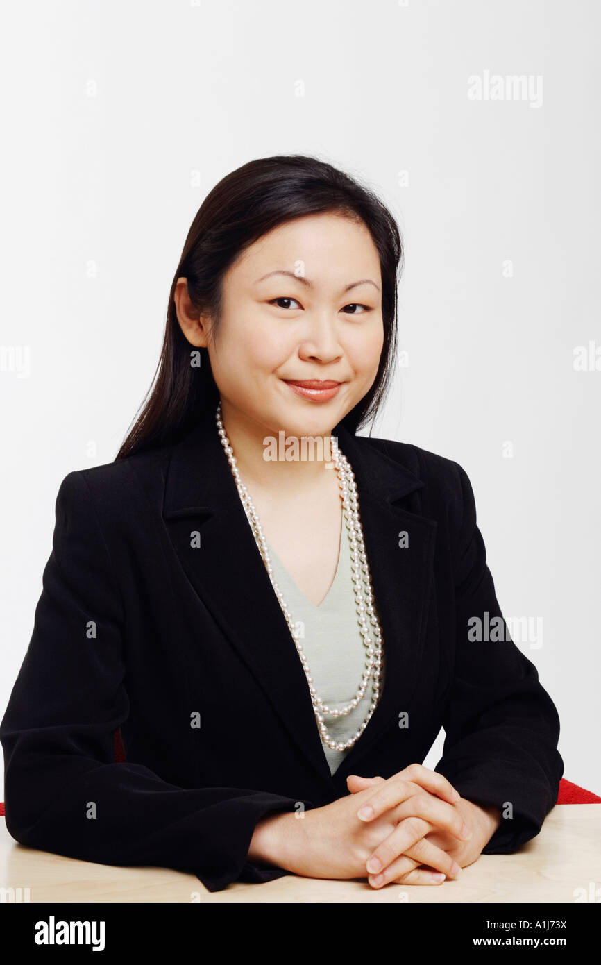 Portrait of a businesswoman sitting in an office and smiling Stock Photo