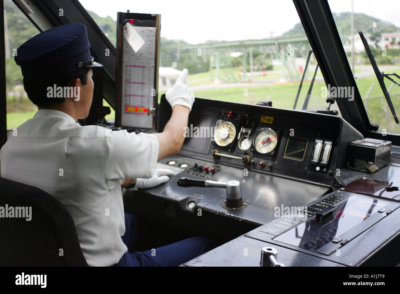 The inside of a train cab with a driver of a Kamome Express train Stock