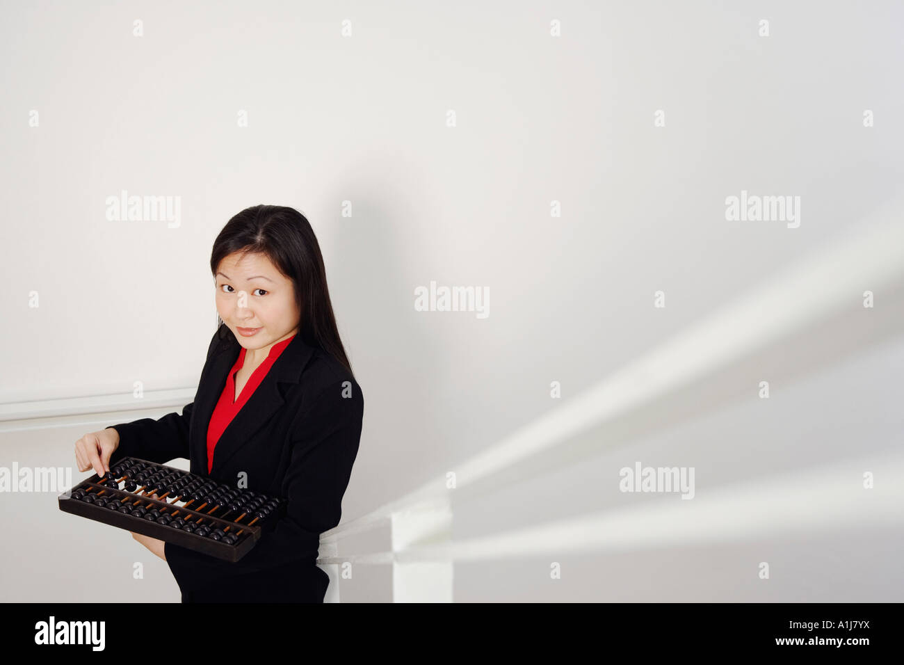 Portrait of a businesswoman holding an abacus and smiling Stock Photo